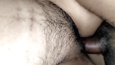 Indian girl fucks her hairy pussy while on the bed
