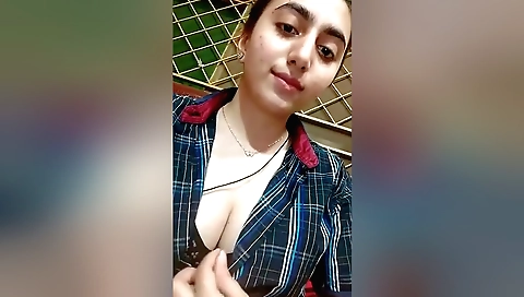 Gorgeous brunette in a white tank top shows off breasts 038a